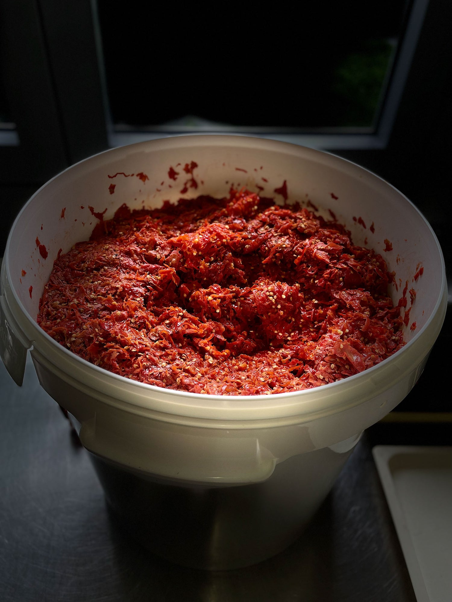 Mushed peppers in a bucket